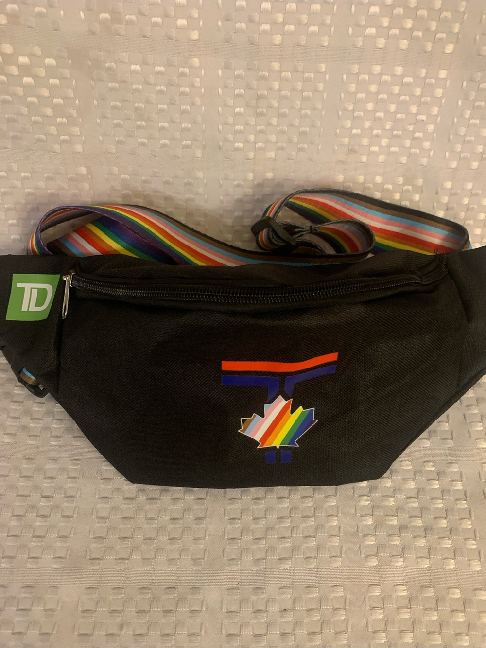 Toronto Blue Jays Pride crossbody bag with rainbow strap.